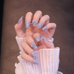 Uñas postizas cuadradas medianas en azul claro con lazo transparente y flor