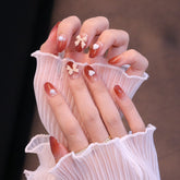 Uñas postizas ombré rojas redondeadas medianas con lazo y corazón