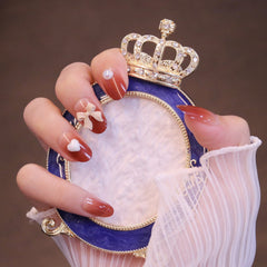 Uñas postizas ombré rojas redondeadas medianas con lazo y corazón