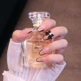 Uñas postizas cuadradas medianas color nude con lazo negro y punta francesa