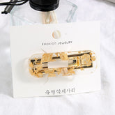 Pinza para el cabello transparente con lámina de oro y plata