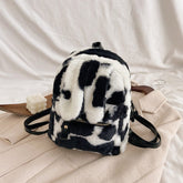 Mochila peluda con orejas de conejo y estampado de vaca