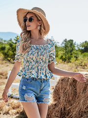 Top de margaritas con mangas abullonadas y fruncido