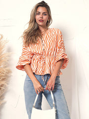 Blusa de manga larga con botones y estampado de cebra