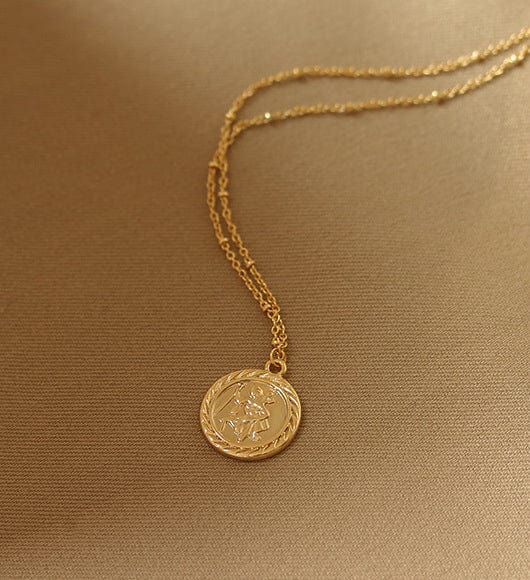 Collar con dije de moneda en relieve dorado