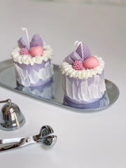 Vela decorativa de pastel de bayas moradas