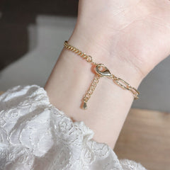 Pulsera asimétrica con colgante de corazón y perla