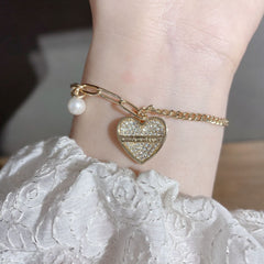 Pulsera asimétrica con colgante de corazón y perla