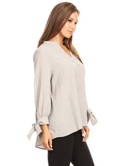 Blusa plisada con mangas abiertas